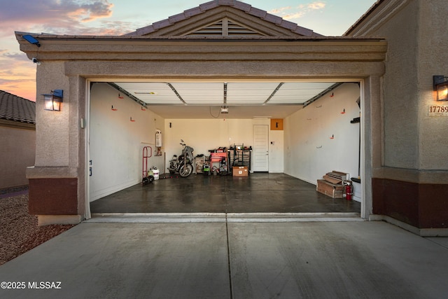 garage featuring concrete driveway