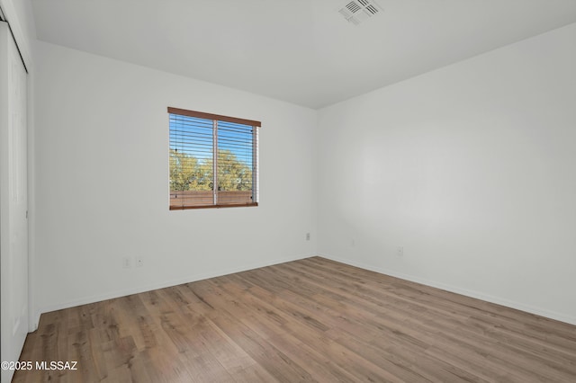 2145 N Horseshoe Trl, Tucson, AZ 85745 - empty room with wood finished floors and baseboards