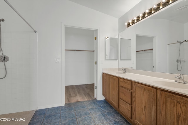 2145 N Horseshoe Trl, Tucson, AZ 85745 - bathroom featuring double vanity, tiled shower, and tile patterned flooring