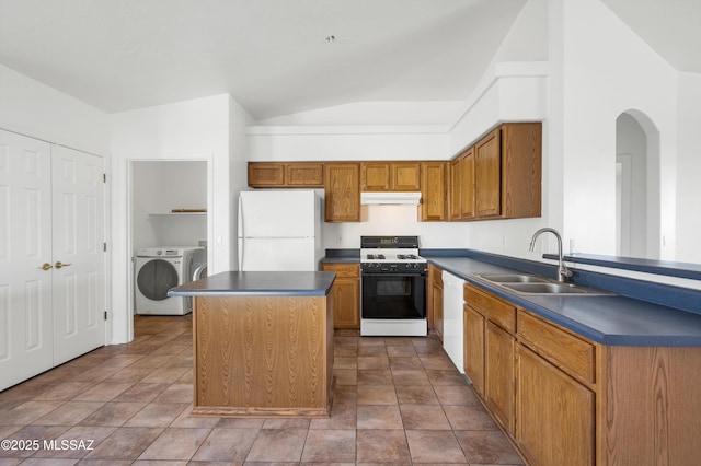 2145 N Horseshoe Trl, Tucson, AZ 85745 - kitchen with white appliances, a sink, dark countertops, under cabinet range hood, and washer and clothes dryer