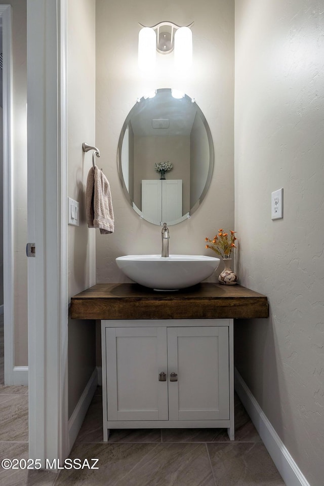 bathroom featuring baseboards and vanity