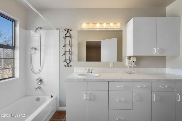 bathroom with tile patterned floors, vanity, and washtub / shower combination