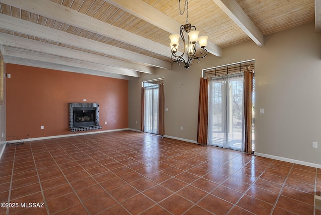 unfurnished living room with tile patterned floors, wood ceiling, baseboards, a notable chandelier, and a brick fireplace