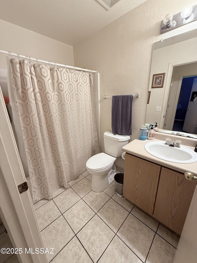 2019 W Calle Cielo De Oro, Tucson, AZ 85746 - bathroom with tile patterned floors, vanity, a textured wall, toilet, and a shower with shower curtain