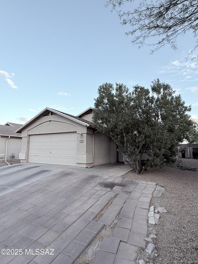 2019 W Calle Cielo De Oro, Tucson, AZ 85746 - view of front facade with an attached garage, driveway, and stucco siding