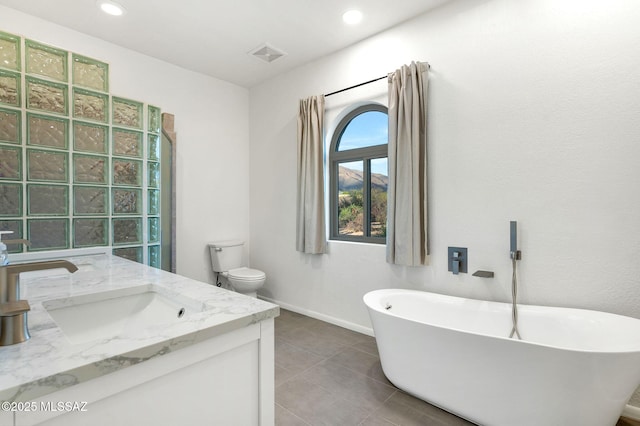 6210 N Camino Pimeria Alta, Tucson, AZ 85718 - full bath with a freestanding bath, vanity, toilet, baseboards, and tile patterned flooring