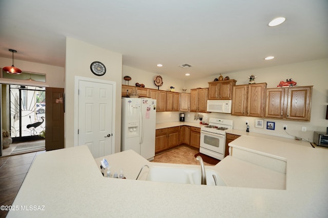 kitchen featuring a sink, white appliances, light countertops, visible vents, and recessed lighting