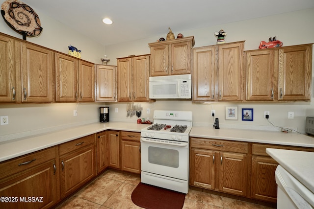 kitchen with brown cabinets, white appliances, light tile patterned floors, light countertops, and recessed lighting