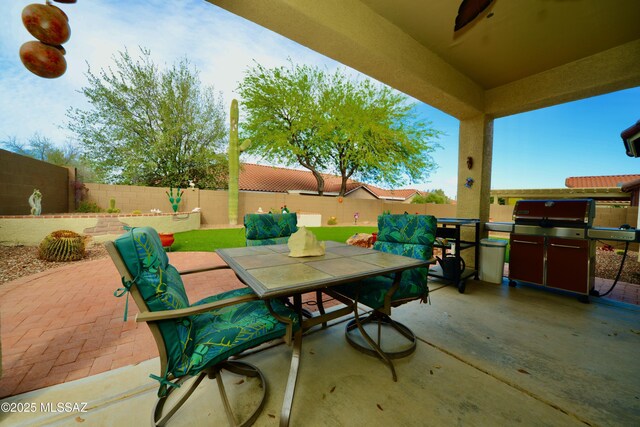 view of patio / terrace featuring outdoor dining space, area for grilling, and a fenced backyard