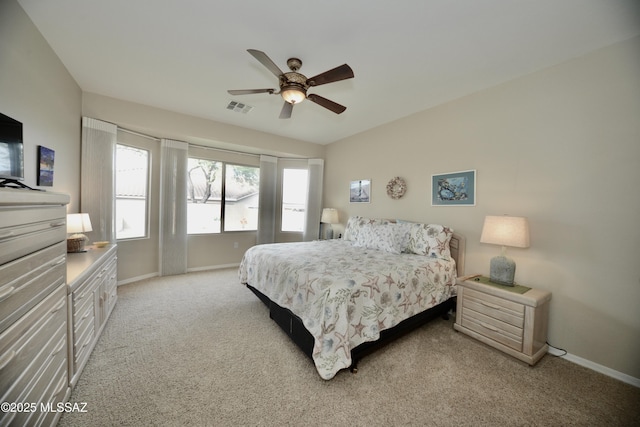 bedroom with visible vents, a ceiling fan, baseboards, and light colored carpet