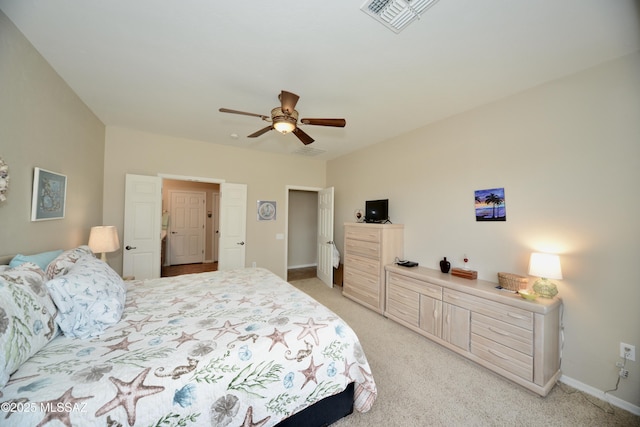 bedroom with light carpet, visible vents, and baseboards