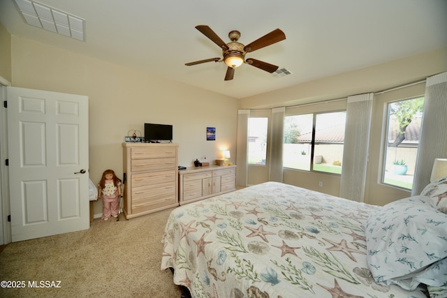 bedroom featuring ceiling fan, visible vents, and light colored carpet