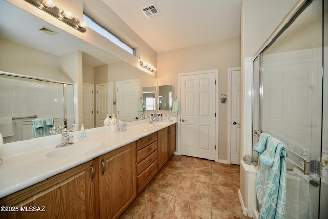 bathroom featuring a sink, visible vents, and a stall shower