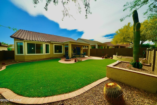 back of house with a patio area, a fenced backyard, a tiled roof, and stucco siding