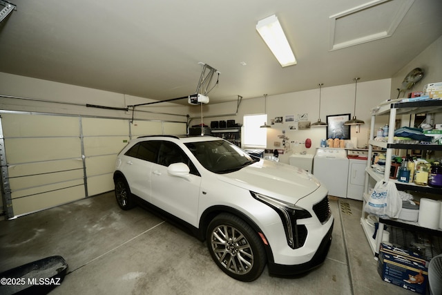 garage featuring independent washer and dryer and a garage door opener