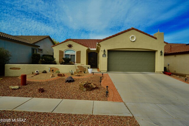 mediterranean / spanish-style house with stucco siding, a tiled roof, driveway, and a garage