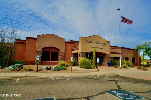 view of property featuring uncovered parking