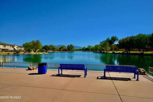 surrounding community with a water and mountain view