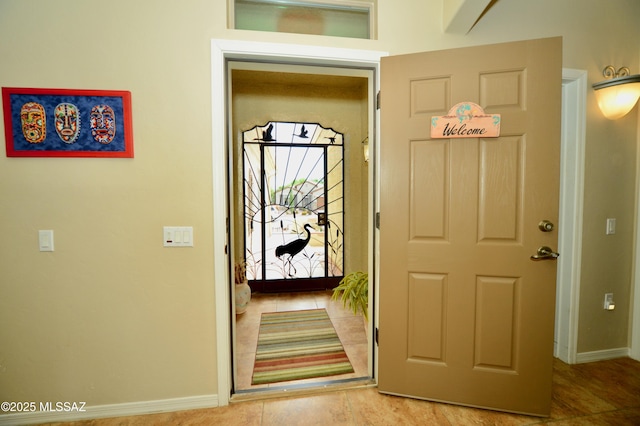 tiled entrance foyer featuring baseboards