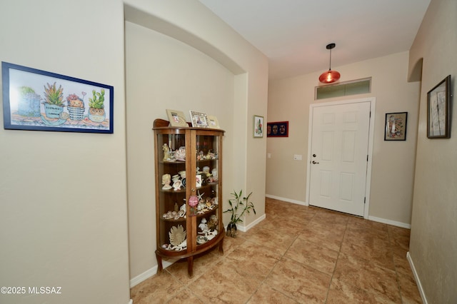 entryway with baseboards and visible vents