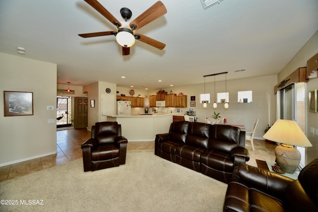 living room featuring light tile patterned floors, baseboards, visible vents, and ceiling fan