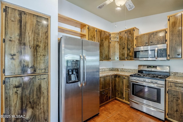 kitchen featuring a ceiling fan and stainless steel appliances