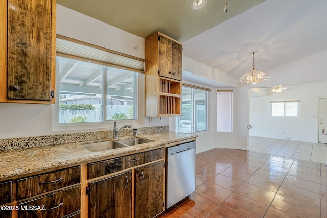 kitchen featuring lofted ceiling, tile patterned floors, stainless steel dishwasher, a sink, and ceiling fan