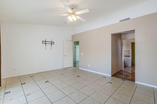unfurnished room featuring a ceiling fan, visible vents, and light tile patterned floors