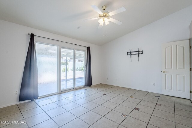 spare room with light tile patterned flooring, lofted ceiling, and ceiling fan