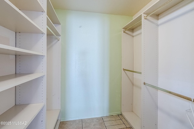 spacious closet featuring light tile patterned floors