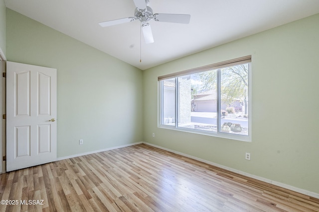 unfurnished room with light wood-style floors and baseboards