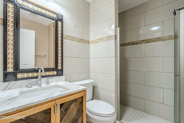 full bathroom featuring a shower stall, visible vents, toilet, vanity, and tile walls