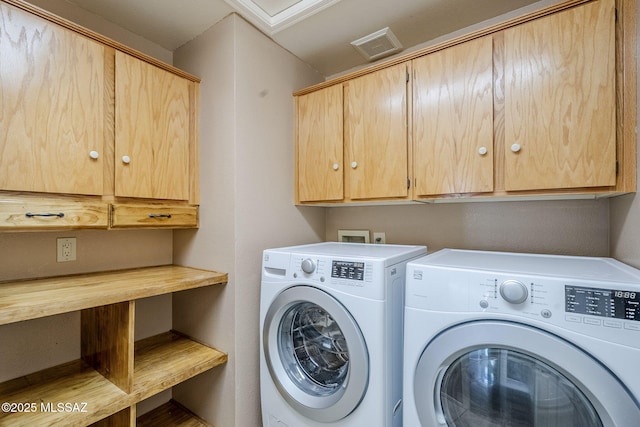 laundry room featuring cabinet space, washing machine and dryer, and visible vents