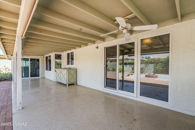 view of patio featuring a fire pit and a ceiling fan