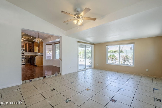 unfurnished room with plenty of natural light, baseboards, ceiling fan, and light tile patterned floors