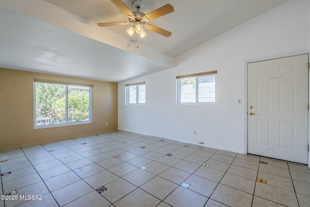 empty room featuring light tile patterned flooring, lofted ceiling, a ceiling fan, and baseboards