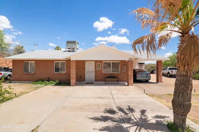 889 Paseo Los Mochis Unit 10, Rio Rico, AZ 85648 - ranch-style home featuring driveway, brick siding, and central air condition unit