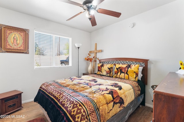 889 Paseo Los Mochis Unit 10, Rio Rico, AZ 85648 - bedroom with wood finished floors, baseboards, and ceiling fan