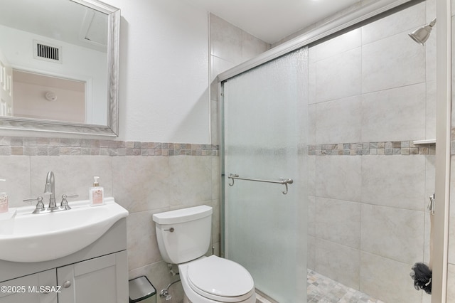 889 Paseo Los Mochis Unit 10, Rio Rico, AZ 85648 - bathroom featuring a shower stall, visible vents, toilet, and vanity