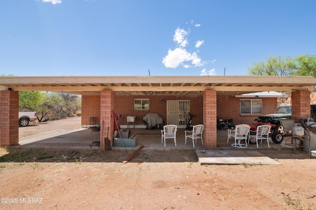 889 Paseo Los Mochis Unit 10, Rio Rico, AZ 85648 - rear view of property featuring brick siding and a patio