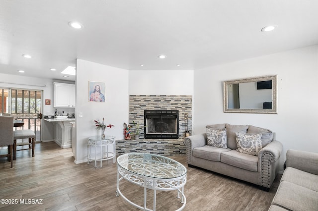 889 Paseo Los Mochis Unit 10, Rio Rico, AZ 85648 - living room with light wood-style floors, a fireplace with raised hearth, and recessed lighting