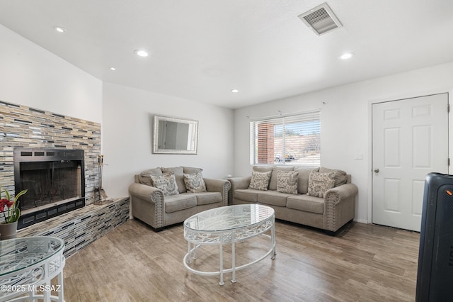 889 Paseo Los Mochis Unit 10, Rio Rico, AZ 85648 - living room with wood finished floors, visible vents, a tile fireplace, and recessed lighting