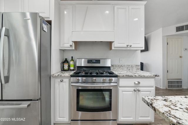 889 Paseo Los Mochis Unit 10, Rio Rico, AZ 85648 - kitchen featuring stainless steel appliances, visible vents, and white cabinetry