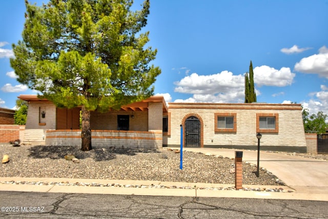 ranch-style home with fence and brick siding
