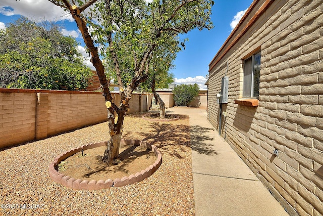 view of yard featuring a patio area and a fenced backyard