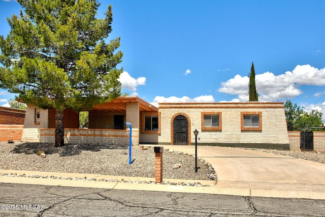 view of front of home featuring driveway and brick siding