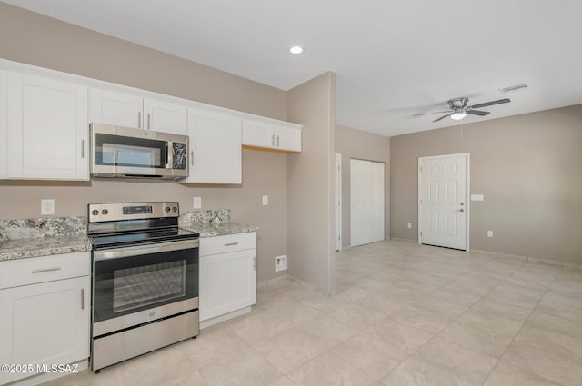 358 W Elvira Rd, Tucson, AZ 85756 - kitchen featuring visible vents, white cabinets, appliances with stainless steel finishes, a ceiling fan, and light stone countertops