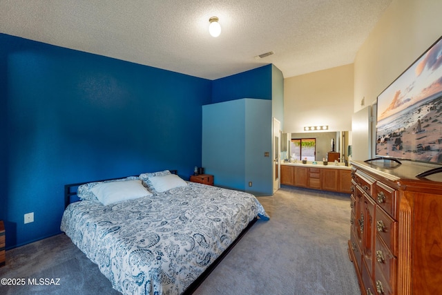 10101 E Bryonwood Ln, Tucson, AZ 85730 - bedroom featuring carpet floors, ensuite bathroom, and a textured ceiling