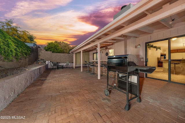 10101 E Bryonwood Ln, Tucson, AZ 85730 - patio terrace at dusk featuring a fenced backyard and area for grilling