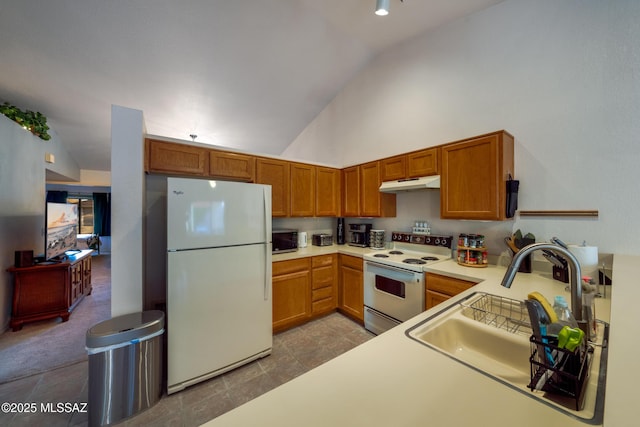 10101 E Bryonwood Ln, Tucson, AZ 85730 - kitchen with a sink, white appliances, light countertops, high vaulted ceiling, and under cabinet range hood